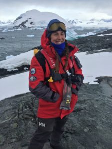 Chloe Power wearing heavy jacket and goggles, standing in front of a Polar landscape